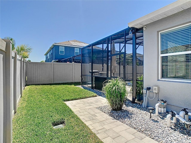 view of yard with a lanai, a patio, and a fenced backyard