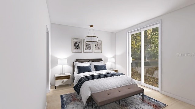 bedroom featuring light wood finished floors, baseboards, and access to outside