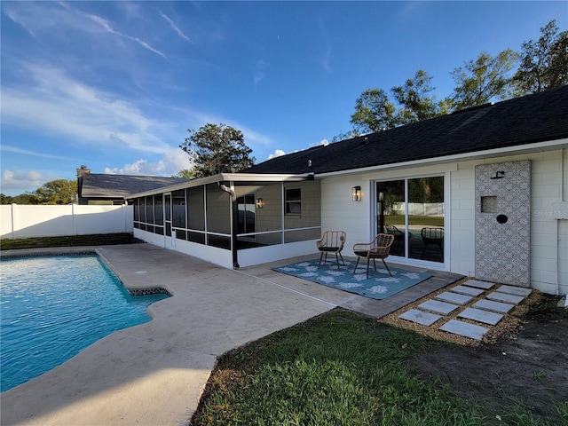 back of house with a fenced in pool, a patio area, fence, and a sunroom