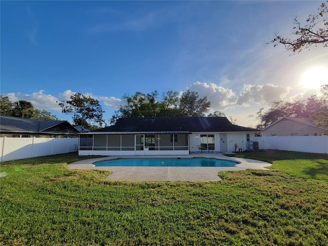 view of pool with a yard, a fenced backyard, and a sunroom