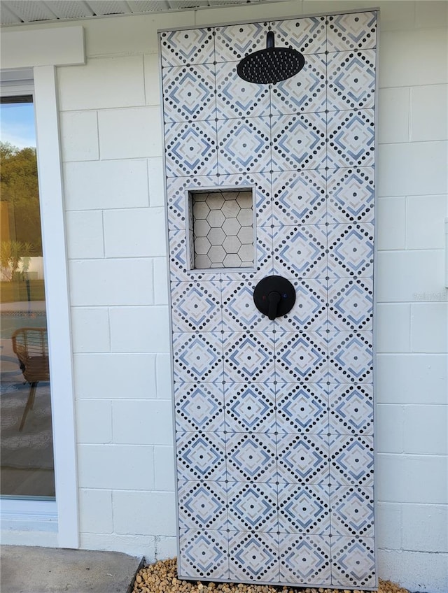 details featuring concrete block siding and a tile shower