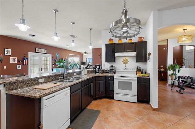 kitchen featuring a sink, french doors, white appliances, a peninsula, and light tile patterned flooring