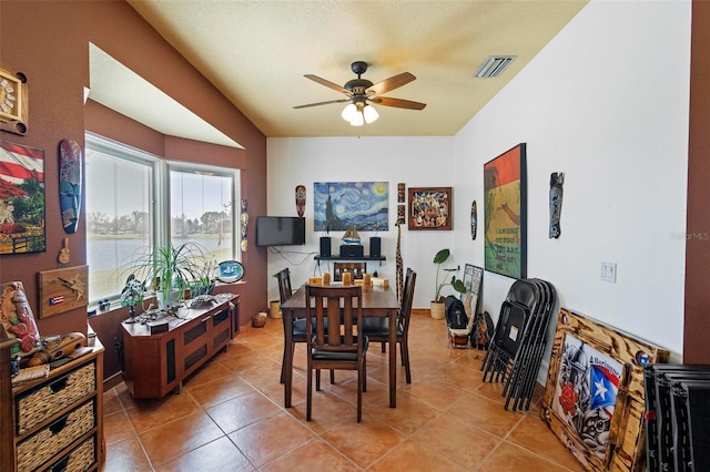 tiled dining room featuring visible vents and ceiling fan