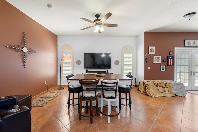 dining space with light tile patterned floors, plenty of natural light, and french doors