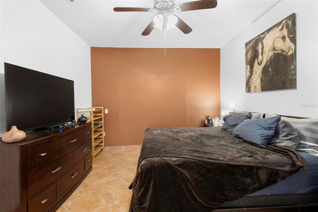 bedroom featuring light tile patterned floors and ceiling fan