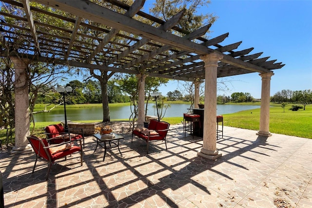 view of patio / terrace with a pergola and a water view