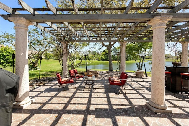 view of patio / terrace featuring a water view, area for grilling, and a pergola