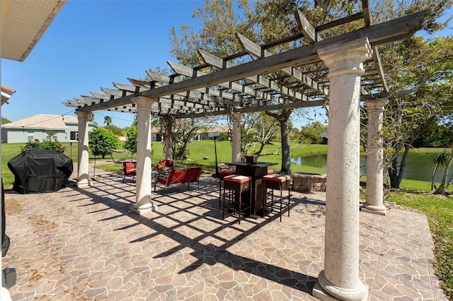 view of patio with a water view, area for grilling, and a pergola