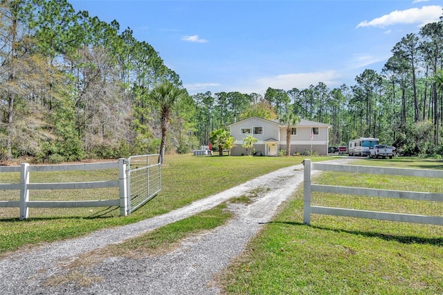 view of gate featuring a yard and fence