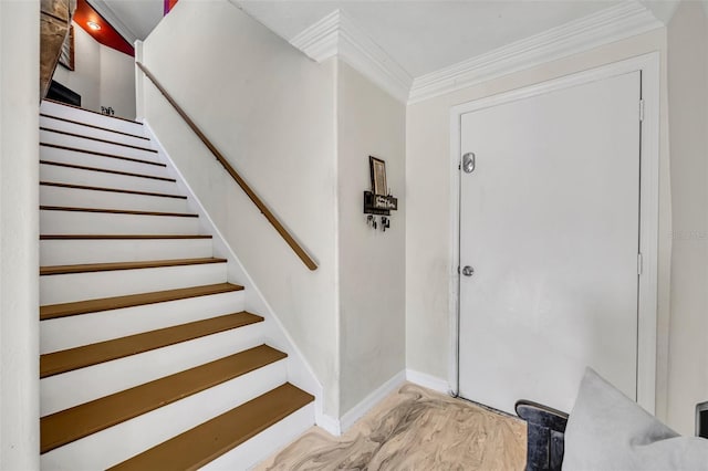 foyer entrance featuring stairs, baseboards, and crown molding