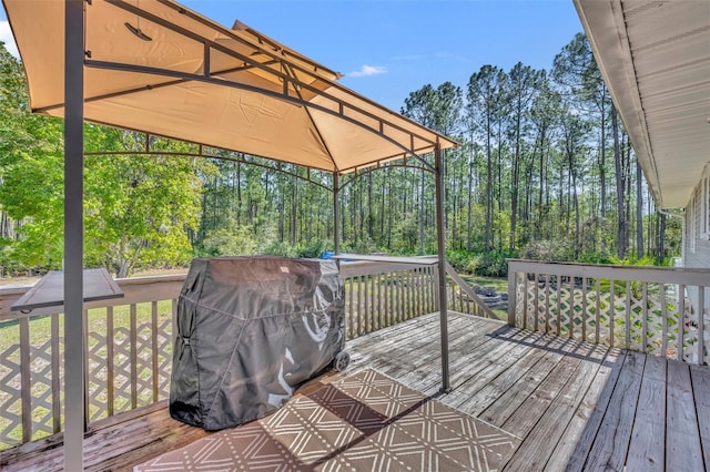 wooden deck with a grill