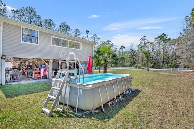 outdoor pool with a lawn and fence