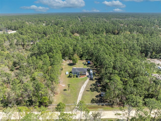 aerial view featuring a wooded view