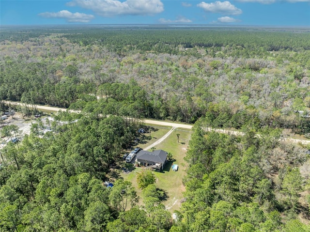 birds eye view of property featuring a wooded view