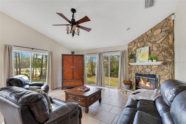 living area featuring visible vents, ceiling fan, a fireplace, light tile patterned flooring, and high vaulted ceiling