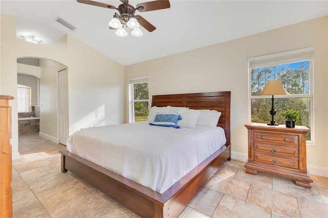 bedroom featuring visible vents, multiple windows, arched walkways, and vaulted ceiling