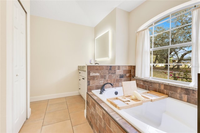 bathroom featuring baseboards, a bath, and tile patterned flooring