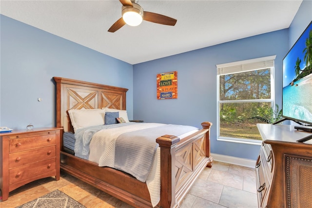 bedroom with a ceiling fan and baseboards