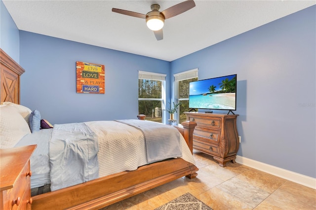 bedroom featuring a ceiling fan and baseboards