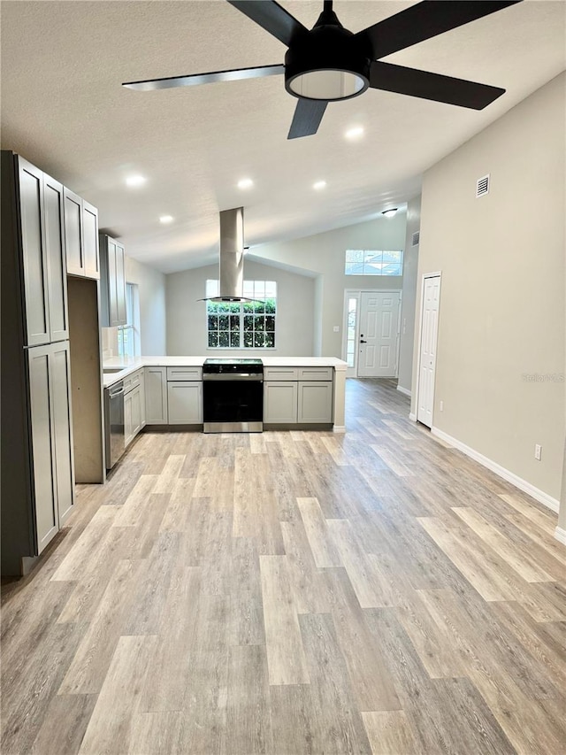 kitchen featuring range with electric cooktop, dishwasher, light countertops, vaulted ceiling, and island range hood