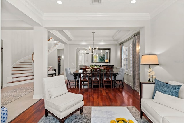 living area with hardwood / wood-style flooring, stairway, and crown molding