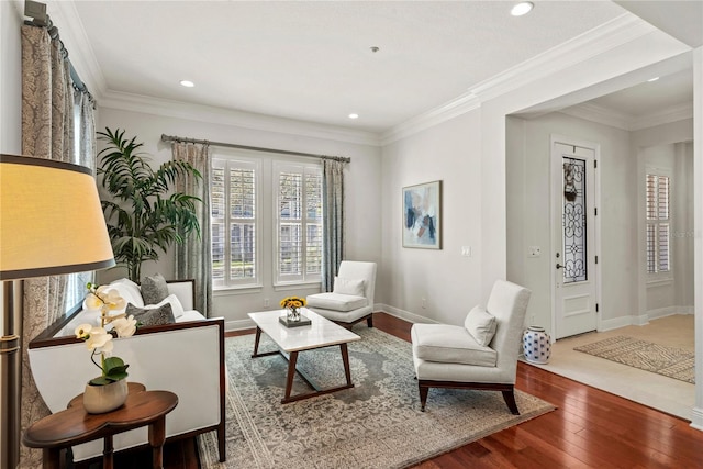 living room featuring recessed lighting, crown molding, baseboards, and wood-type flooring