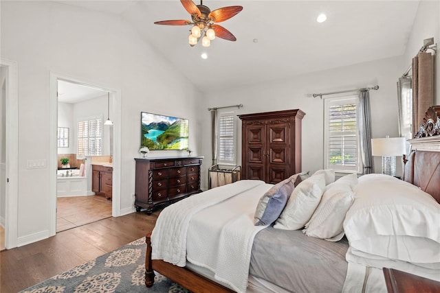 bedroom with ensuite bath, lofted ceiling, recessed lighting, and wood finished floors