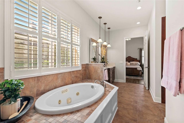 ensuite bathroom with vanity, ensuite bath, recessed lighting, tile patterned flooring, and a jetted tub