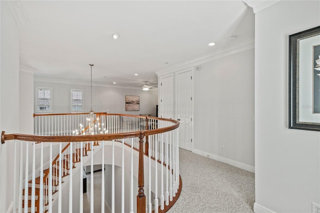 hallway featuring an upstairs landing, a chandelier, crown molding, and carpet