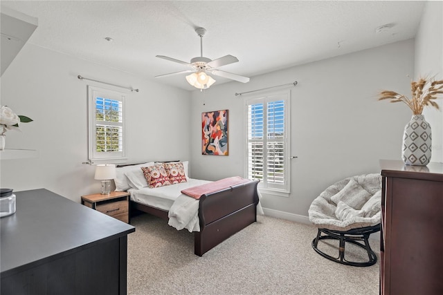 carpeted bedroom featuring a ceiling fan and baseboards