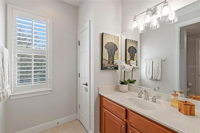 bathroom with vanity, tile patterned floors, and baseboards