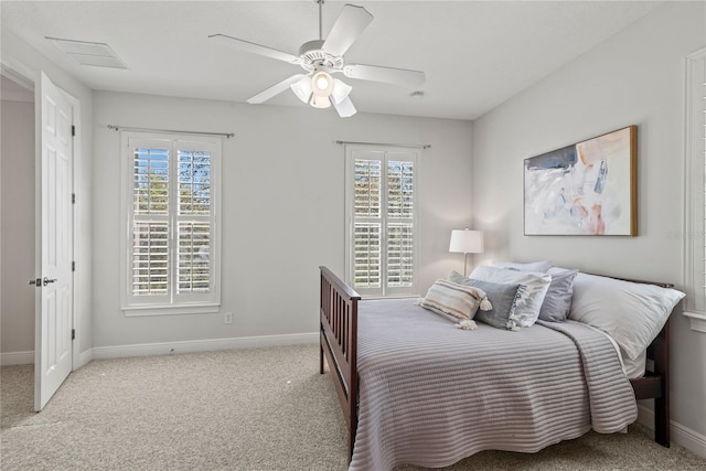 carpeted bedroom with visible vents, baseboards, and ceiling fan