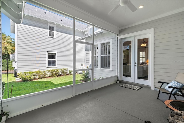 sunroom with a healthy amount of sunlight and ceiling fan