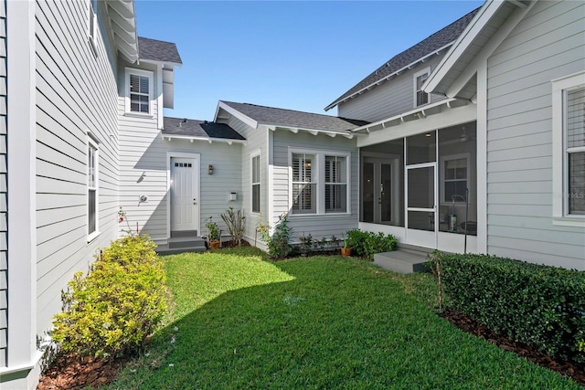 entrance to property featuring a lawn