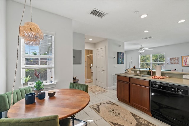 kitchen featuring light tile patterned floors, visible vents, black dishwasher, and a sink