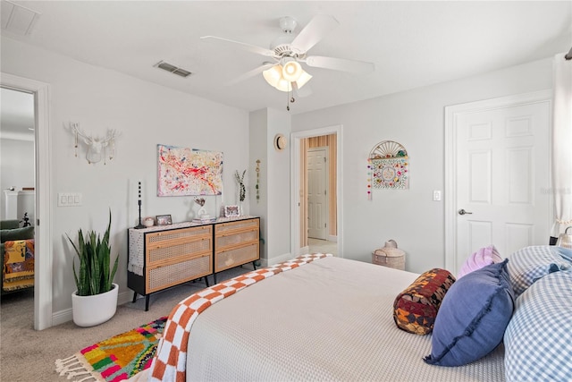 bedroom featuring visible vents, baseboards, light colored carpet, and a ceiling fan