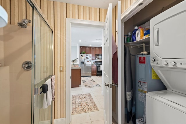 washroom featuring wallpapered walls, laundry area, light tile patterned floors, and stacked washing maching and dryer