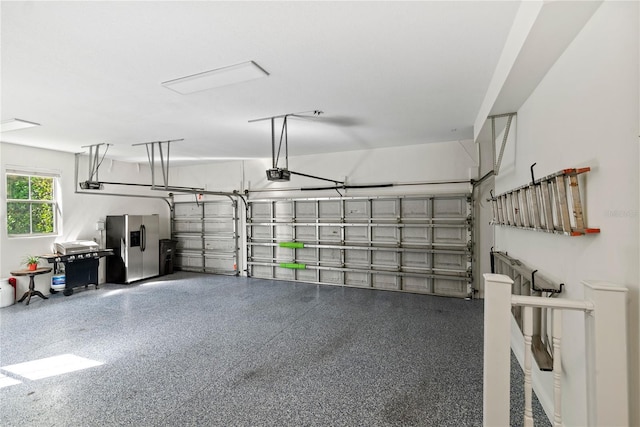 garage featuring a garage door opener and stainless steel fridge with ice dispenser