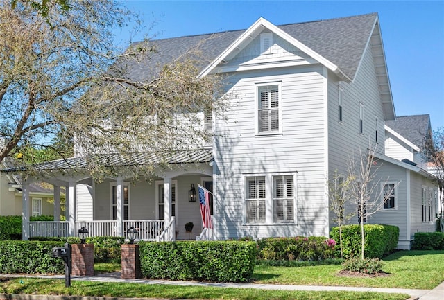 view of front of home with a porch and roof with shingles