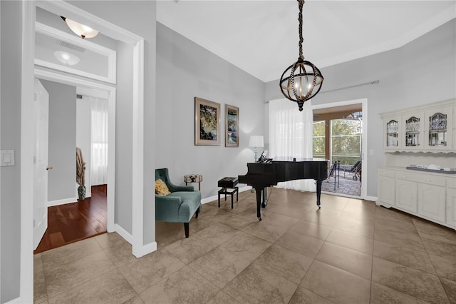 sitting room featuring tile patterned flooring, a notable chandelier, visible vents, and baseboards