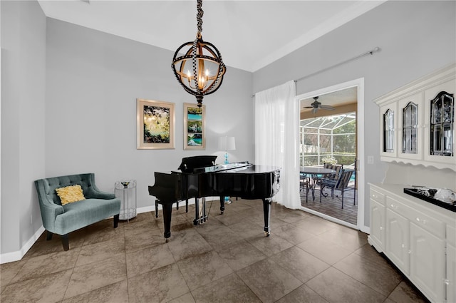 sitting room with baseboards and ceiling fan with notable chandelier