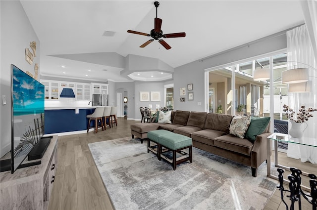 living area featuring visible vents, light wood finished floors, high vaulted ceiling, recessed lighting, and ceiling fan