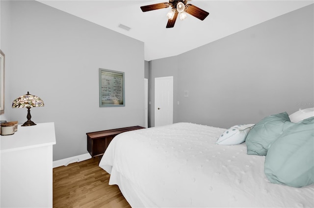 bedroom with visible vents, baseboards, light wood-style floors, and a ceiling fan