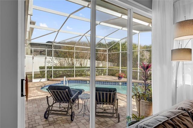 outdoor pool with glass enclosure and a patio