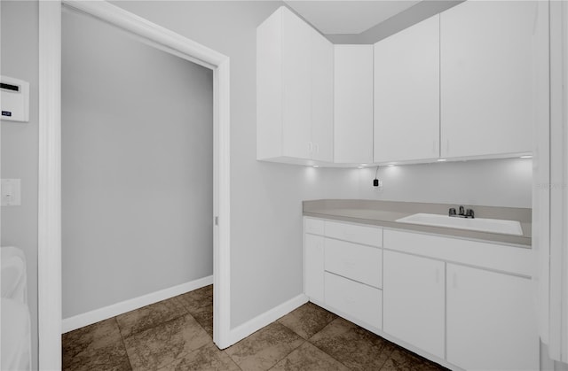 bathroom featuring vanity and baseboards