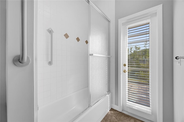 bathroom featuring shower / bath combination with glass door