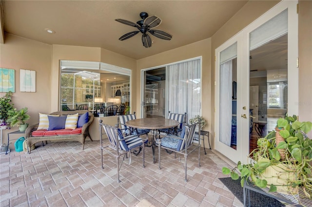 view of patio with outdoor dining space and ceiling fan