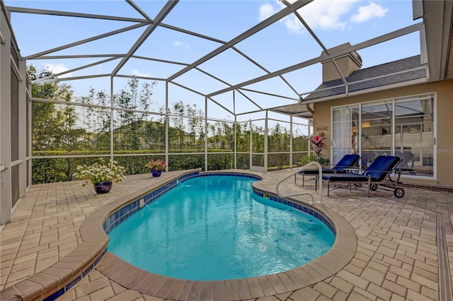 outdoor pool with a patio area and a lanai