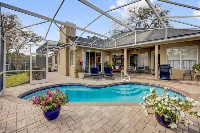 pool featuring a patio area and glass enclosure