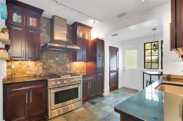 kitchen with visible vents, decorative backsplash, stainless steel stove, dark countertops, and wall chimney exhaust hood